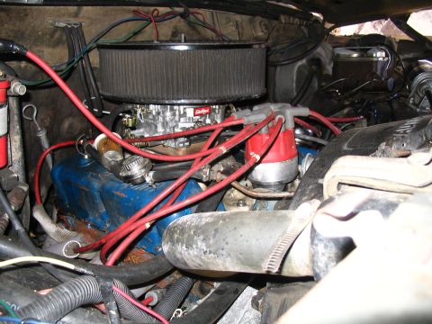 1984 Ford Bronco - Close-up view of an engine bay, highlighting the carburetor, distributor, and associated wiring.