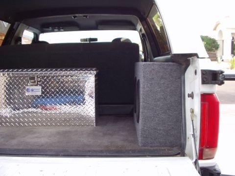 1993 Ford Bronco - Vehicle interior cargo area with a toolbox and subwoofer enclosure visible.
