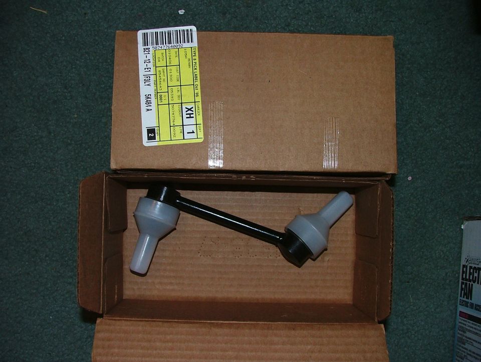 New sway bar end link with white protective caps in a cardboard box with Ford parts label 5K484-A