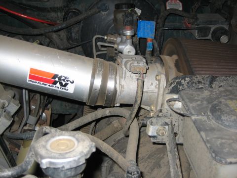1995 Ford Bronco - Close-up view of a K&N High-Flow Air Filters intake system installed in an engine bay.