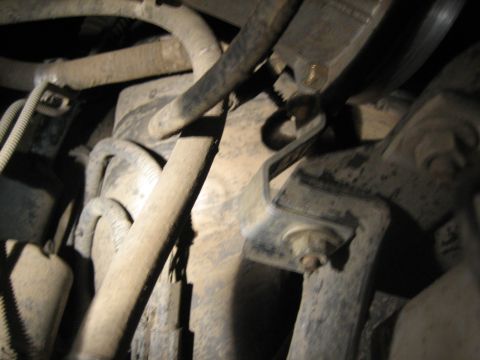 1995 Ford Bronco - Close-up view of engine bay hoses and metal brackets, likely during a K&N filter installation.
