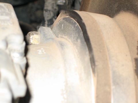 1995 Ford Bronco - Detail shot of a vehicle's brake caliper and rotor, likely during maintenance or repair.