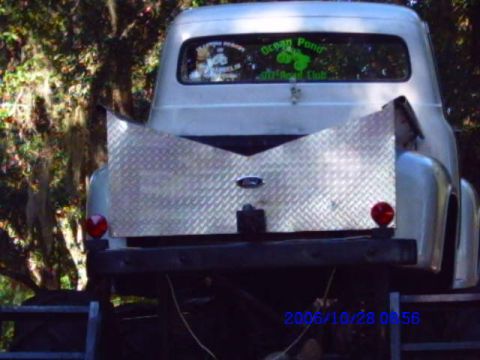 1987 Suzuki Samurai - This silver pickup truck features a diamond plate tailgate insert and stickers on its rear window, including one for 'Ocean Pond Off-Road C…