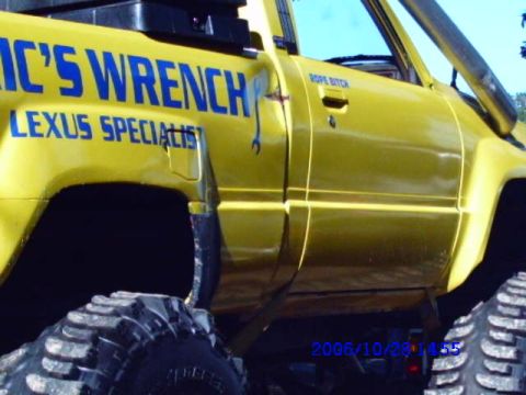 1987 Suzuki Samurai - A yellow pickup truck with custom lettering on the side, including "IC'S WRENCH LEXUS SPECIALIST" and "ROPE BITCH".