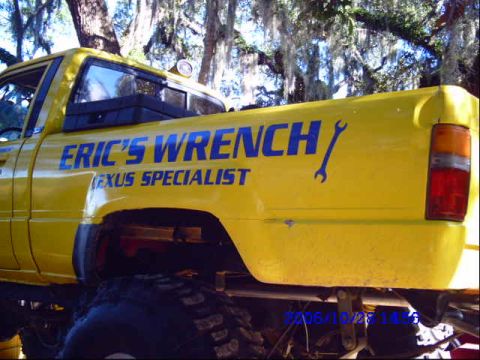 1987 Suzuki Samurai - A yellow pickup truck with "Eric's Wrench Lexus Specialist" written on the side.