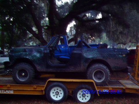 1987 Suzuki Samurai - International Harvester Scout II on a trailer, showing its side profile and blue interior.