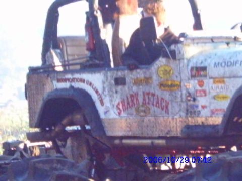 1987 Suzuki Samurai - This heavily modified Jeep sports numerous decals and appears to be off-roading.