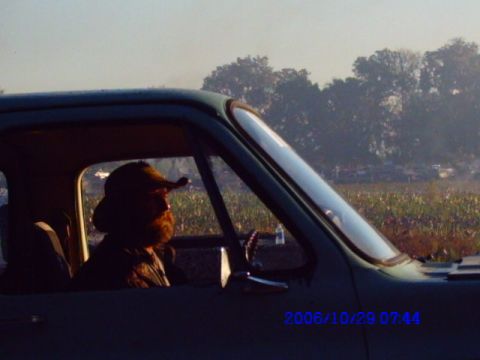 1987 Suzuki Samurai - A man with a beard and hat is seen from the side, driving a vehicle. The date stamp indicates the photo was taken on October 29, 2006.