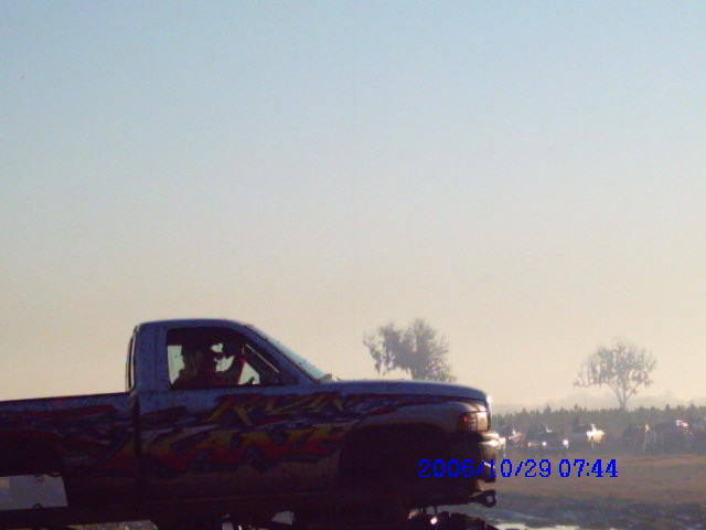 Pickup truck with flame graphics on the side, seen from the side. Date stamp reads 2006/10/29 07:44