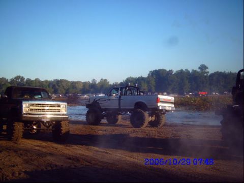 1987 Suzuki Samurai - Lifted pickup trucks are seen in a muddy field under a clear blue sky. The timestamp indicates the photo was taken on October 29, 2006.