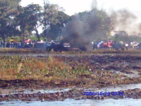 1987 Suzuki Samurai - A muddy field is filled with vehicles and smoke, suggesting a competition or event took place on October 29, 2006.