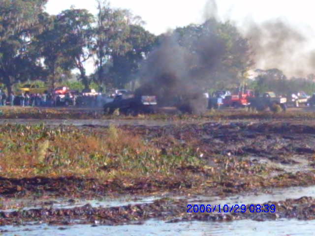 Mud bogging scene with smoke and multiple vehicles, dated 2006/10/29