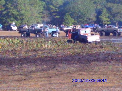 1987 Suzuki Samurai - Multiple trucks are seen in a muddy field during an event, with a date stamp of 2006/10/29.
