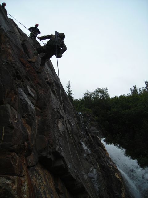 2003 Jeep TJ - Military personnel practice rappelling down a cliff beside a cascading waterfall.