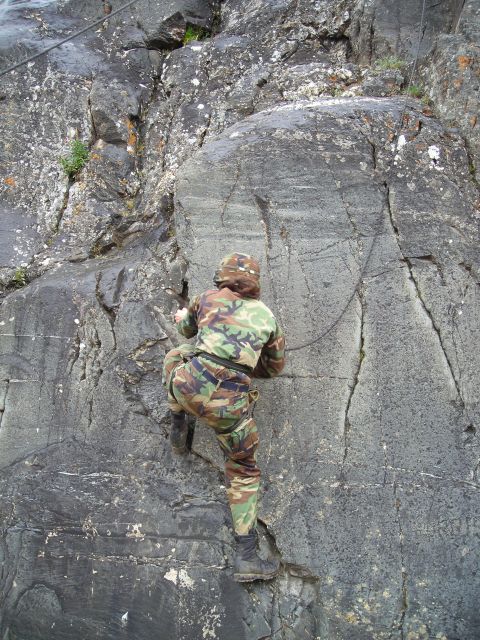 2003 Jeep TJ - A climber ascends a rock face, using a rope for safety.