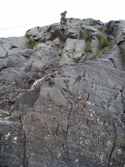 2003 Jeep TJ - A person surveys the landscape from the summit of a , grey rock formation.