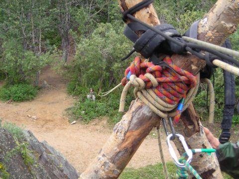 2003 Jeep TJ - Ropes and rigging are attached to wooden poles in a natural outdoor setting.