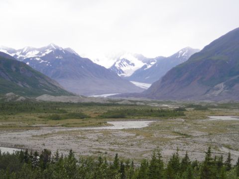 2003 Jeep TJ - A vast glacial valley stretches between snow-capped mountains under an overcast sky.