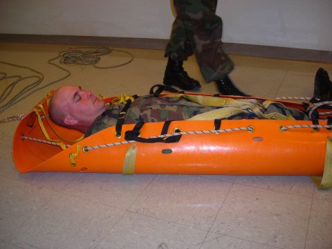 2003 Jeep TJ - A soldier is transported in a medical stretcher, with another soldier attending.