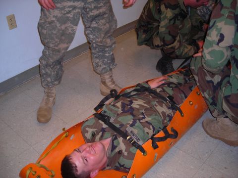 2003 Jeep TJ - Military personnel practice casualty evacuation with a stretcher.