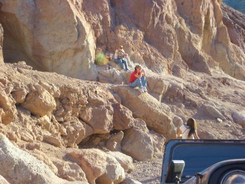1985 Ford Bronco - A group of people take a break while exploring a rocky desert environment.