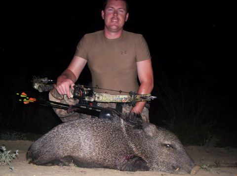 2005 BMW 3 Series - Hunter poses with a javelina after a successful hunt at night.