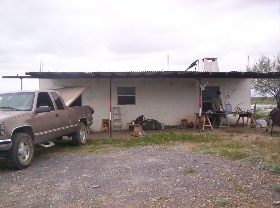Brown pickup truck parked in front of a building