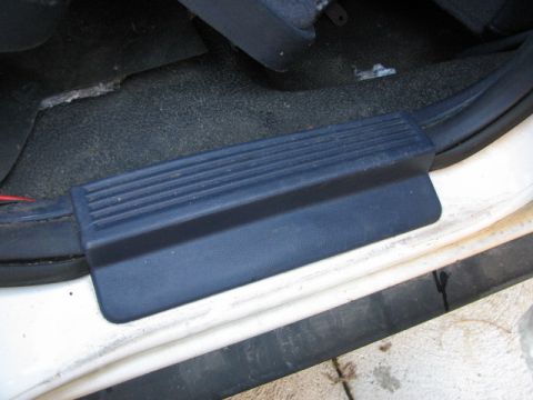 2003 Ford Crown Victoria - Interior door sill trim piece with ribbed texture is visible.