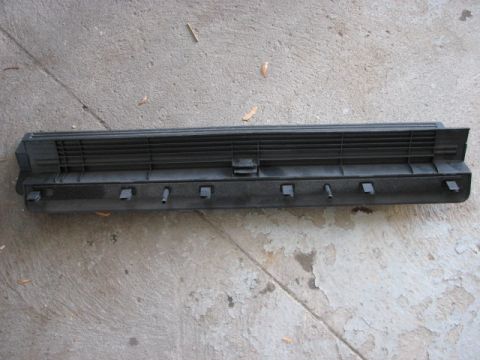 2003 Ford Crown Victoria - This is a black plastic car part, likely a vent or trim piece, shown from the underside with visible mounting clips.