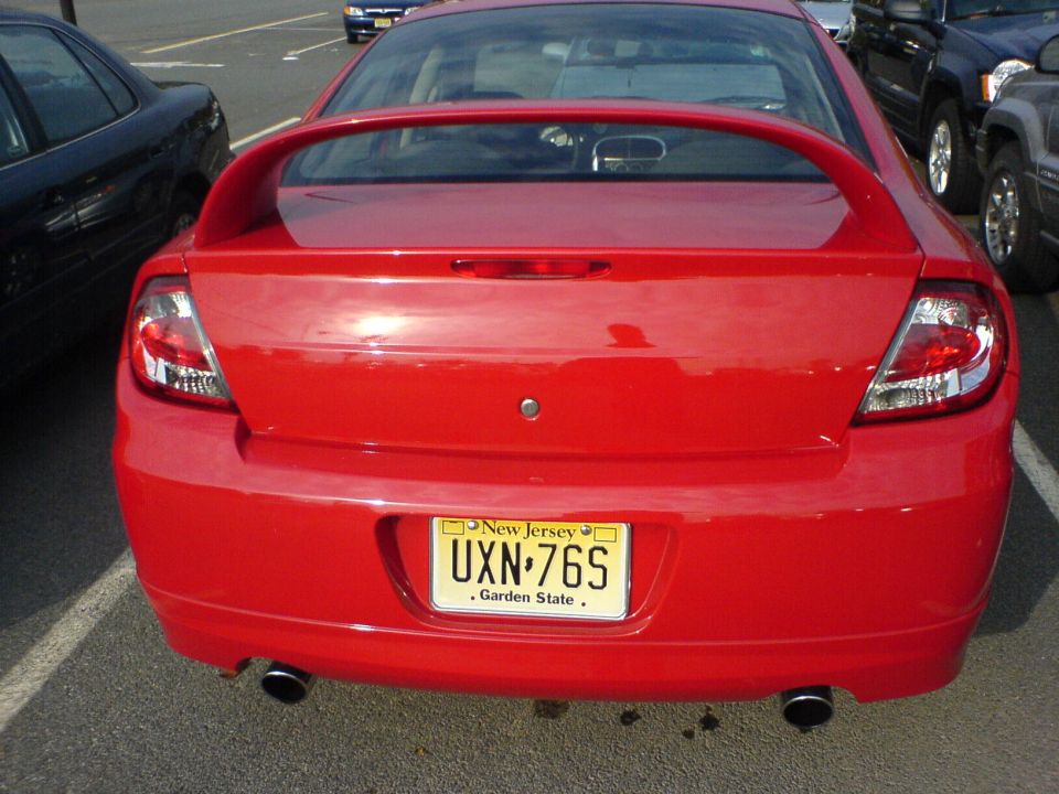 Red 2005 Dodge SRT-4 rear view with New Jersey license plate UXN-76S. Other cars parked nearby