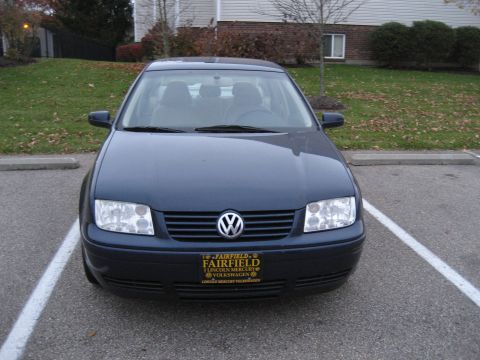 2002 Volkswagen Jetta - Front view of a dark blue 2002 Volkswagen Jetta, parked in a lot with a dealership license plate.