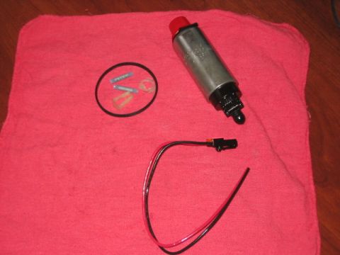 1991 Ford Bronco - Fuel pump assembly with associated parts laid out on a red cloth for installation or repair.