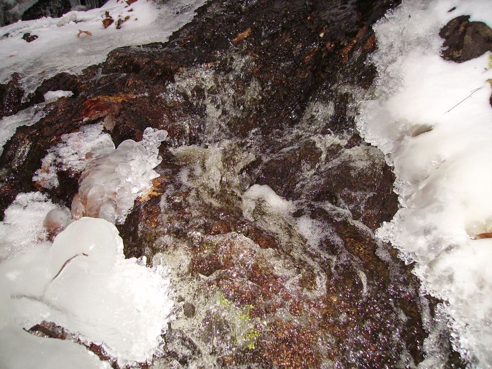 Waterfall with ice and rocks, Supermotors.net logo in lower right