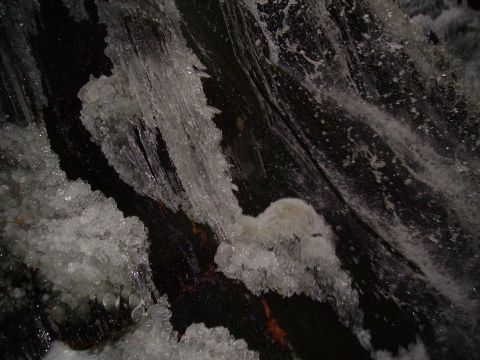 2000 Chevrolet Tahoe - Frozen waterfall with ice formations and water splashes, as seen at Hungarian Falls.