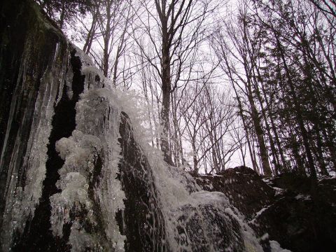 2000 Chevrolet Tahoe - Winter scene with a partially frozen waterfall and surrounding forest.