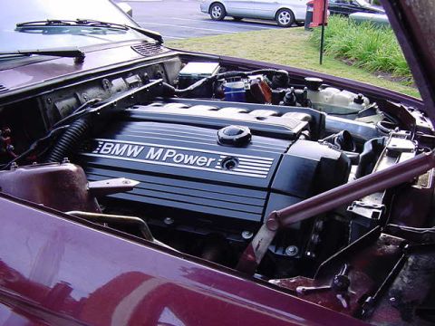 1984 BMW 3 Series - Close-up view of a BMW M Power engine, with the hood open.