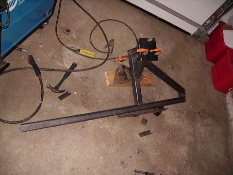 2000 Chevrolet Tahoe - Metal parts and welding equipment are laid out on a concrete floor, suggesting a fabrication project.