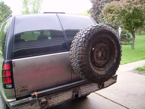 2000 Chevrolet Tahoe - Rear view of a 2000 Chevrolet Tahoe showing a spare tire mounted on a custom bumper with a Draper logo.