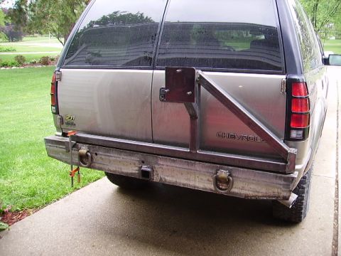 2000 Chevrolet Tahoe - Rear view of a silver Chevrolet Tahoe a custom metal bumper and spare tire carrier.