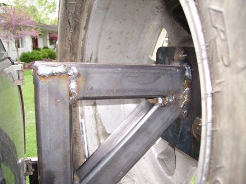 2000 Chevrolet Tahoe - Custom metal fabrication, possibly a trailer hitch or bumper modification, near a tire.