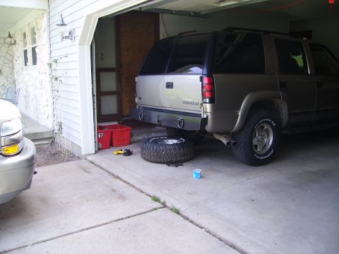 2000 Chevrolet Tahoe - Rear view of a 2000 Chevrolet Tahoe, spare tire removed and placed on the ground.
