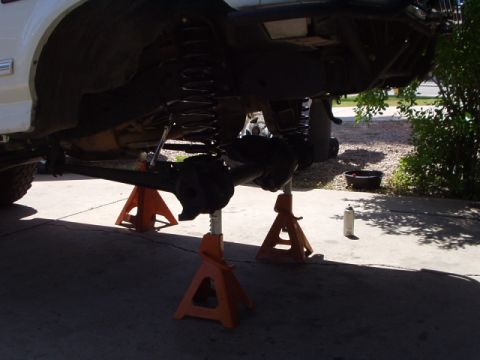 1993 Ford Bronco - Rear suspension of a 1993 Ford Bronco is elevated on jack stands for maintenance.