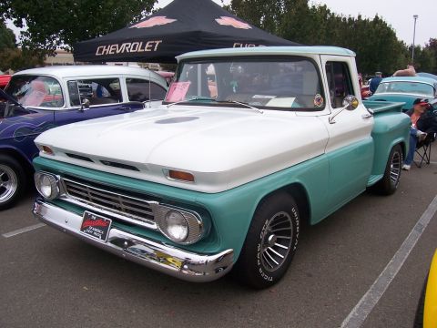 2002 Ford Mustang - Classic two-tone pickup truck parked at an outdoor event, with a Chevrolet tent visible.