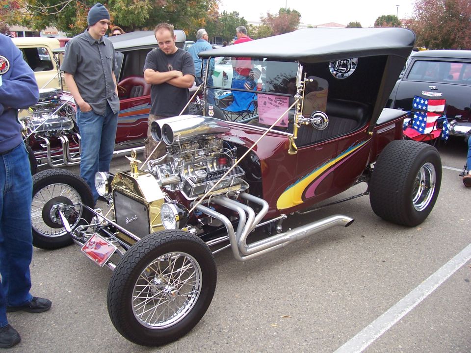 Maroon hot rod with large V8 engine and custom flame graphics