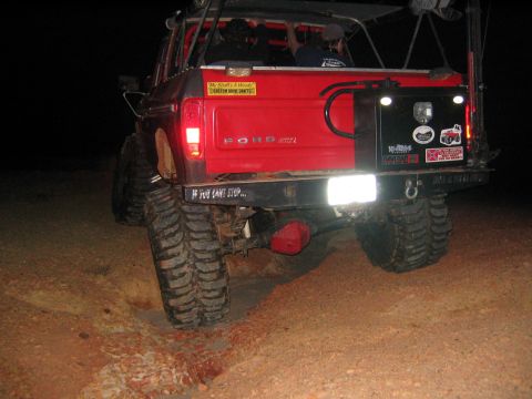 1979 Ford Bronco - Rear view of a red 1979 Ford Bronco equipped for off-roading, large tires and a custom bumper.