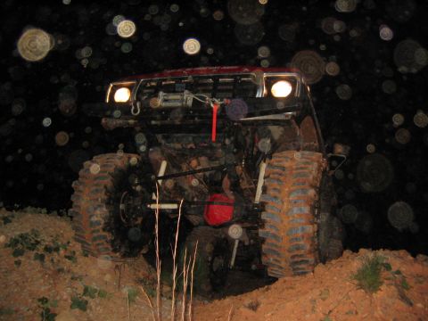1979 Ford Bronco - This heavily modified off-road vehicle is shown at night on a dirt incline.