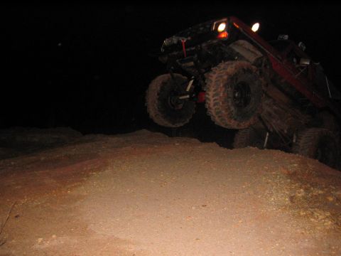 1979 Ford Bronco - An off-road vehicle navigates a challenging terrain, with its tires leaving the ground.