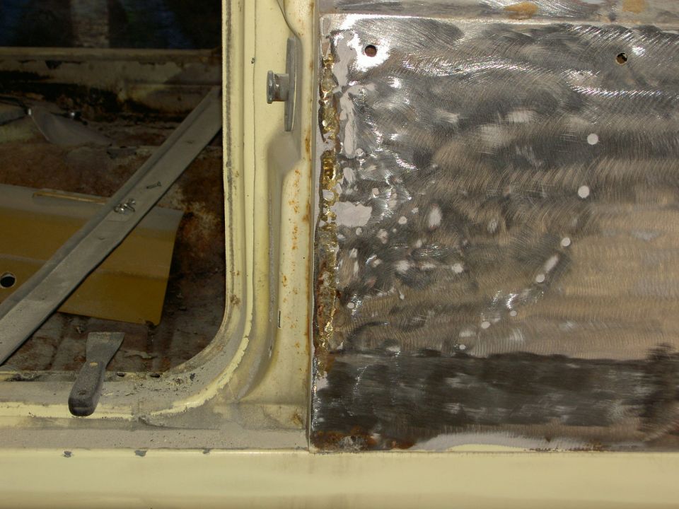 1967 Ford Ranchero door panel repair. Close-up of metalwork