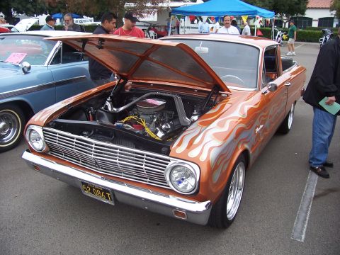 2002 Ford Mustang - This custom pickup truck features flame decals and its hood is open, revealing the engine compartment.