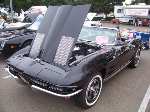 2002 Ford Mustang - A black convertible with its hood open is displayed at an outdoor event.